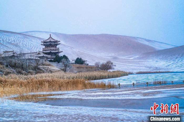 2021年11月28日，雪落鳴沙山月牙泉景區(qū)?！⊥醣筱y 攝